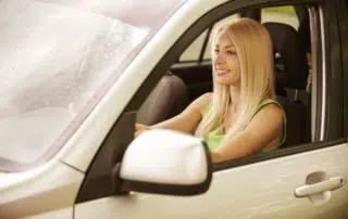 A young woman driving a car