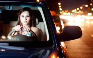 A young girl driving at night