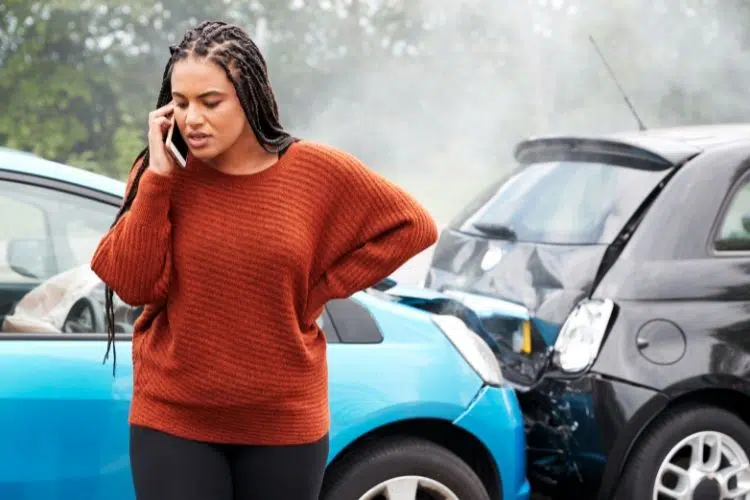 A woman making a phone call after she got into a car accident in florida